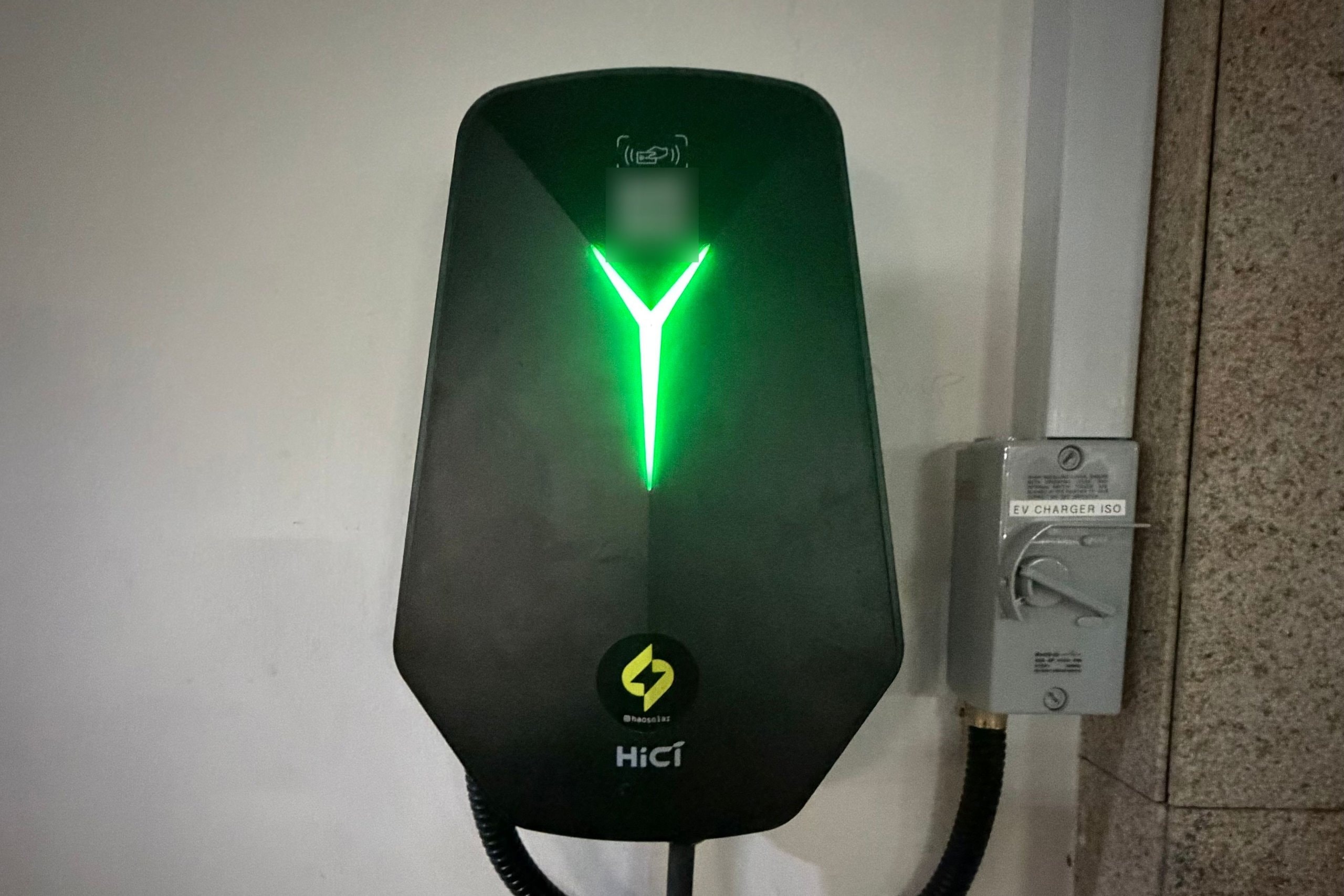 HiCi wall charger installed beside its isolator switch, the green light on
